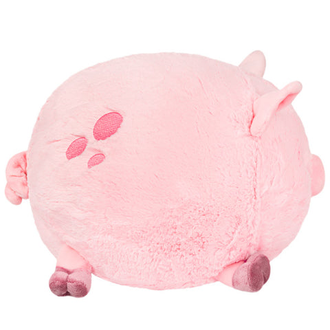 A side view of the plush pig. Its body is very round.