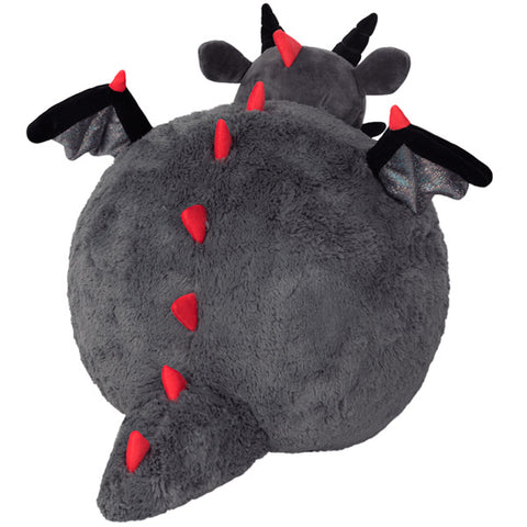 A back view of the plush dragon. It has red spikes down its back.