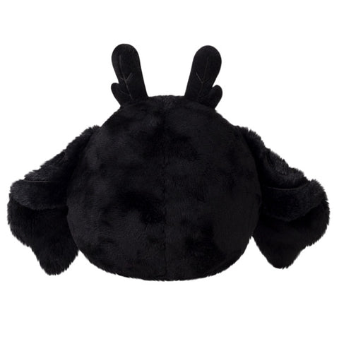 A back view of the plush baby Mothman