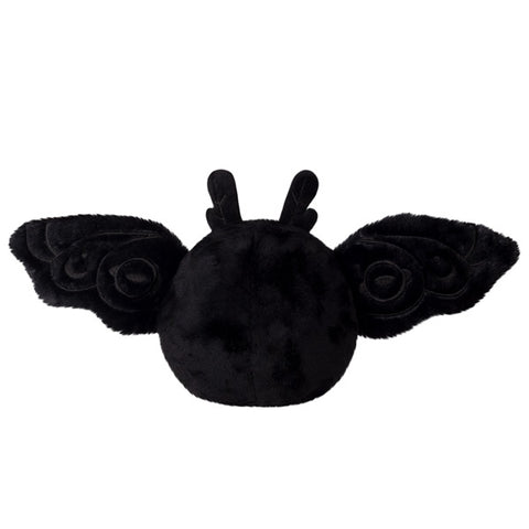 A back view of the plush baby Mothman with its wings open
