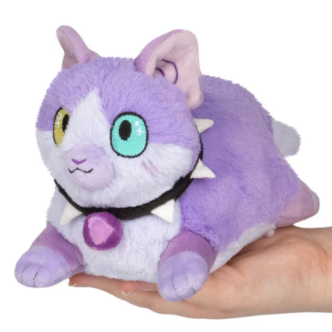Image shows a lavender stuffed cat with bicolored eyes (one yellow one green) and a spike collar.
