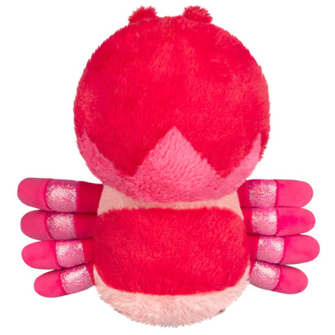 Top-down view of a plush pink tarantula on a white background