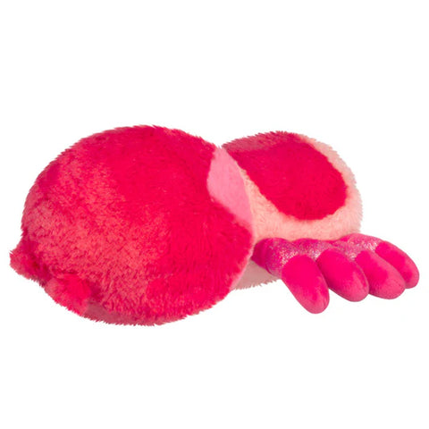 Back-angle view of a pink plush tarantula on a white background