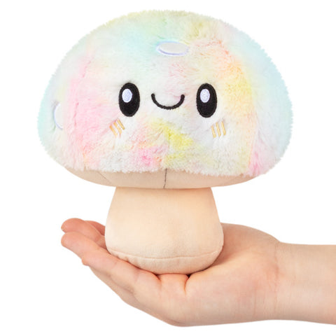Image shows a stuffed pastel tie dye mushroom held in someone's palm