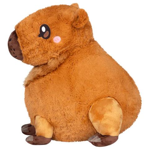 Image shows a side view of the stuffed Capybara. Its round body is made clear.