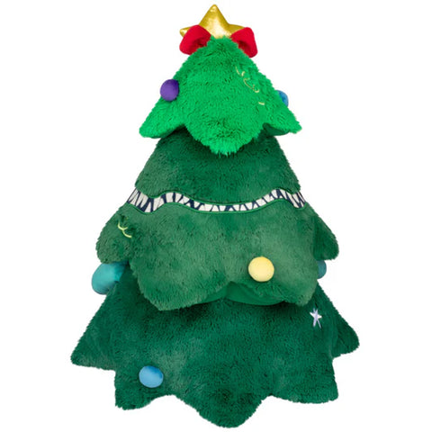 The back view of a Christmas tree with teeth, arms, and various shapes scattered around the tree.