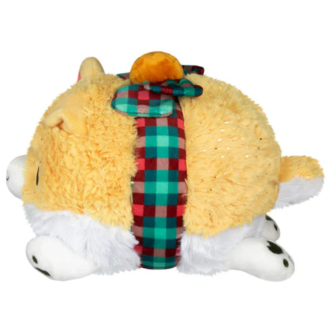 The side view of A round stuffed Corgi with a bow tied around its middle