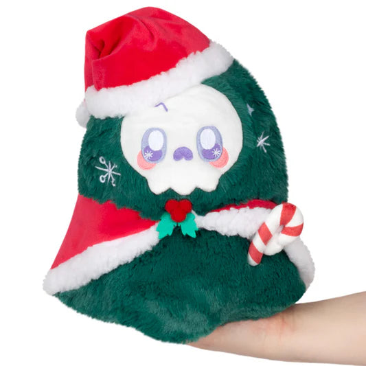 A green stuffed festive Reaper wearing a Santa hat and red & white cape