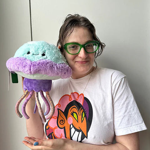 Image shows a woman holding the stuffed jellyfish. It is approximately the side of her head.