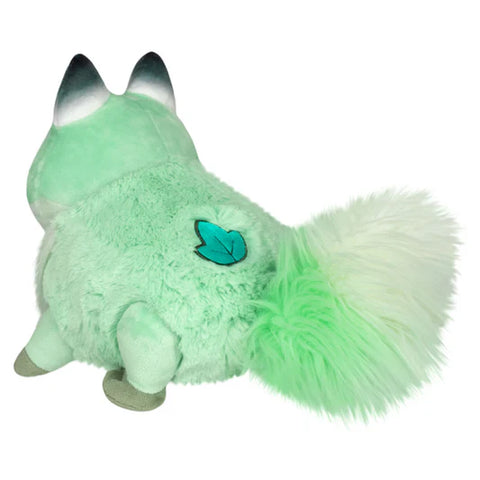 Image shows a back view of the stuffed fox. It has a leaf near its tail.