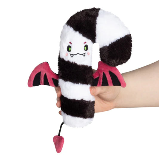 A black and white candy with fangs, bat wings, and a tail