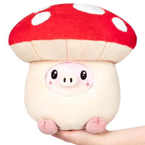 A plush toy depicting a pig inside a mushroom with a predominantly red and white color scheme.