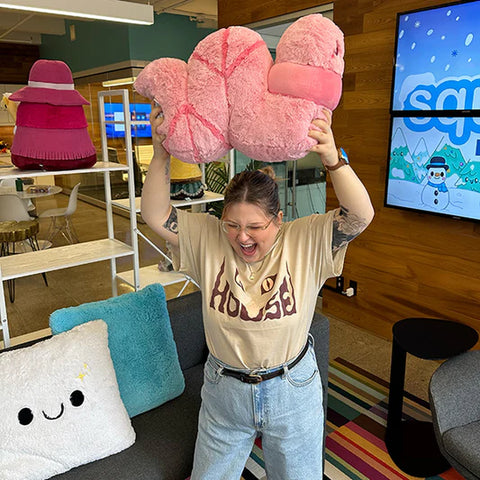 Image shows a woman holding the worm above her head. It is approximately the size of her torso.
