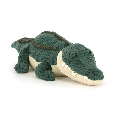 Image shows a stuffed alligator. It has teeth poking out.