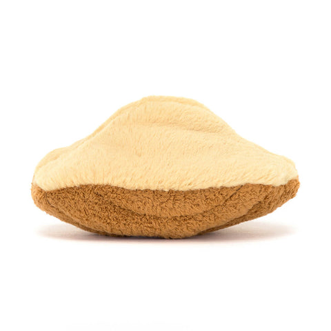 A back view of the plush Madeleine cookie on a white background