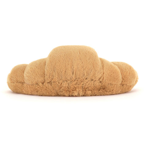 Back view of a Plush toy shaped like a croissant on a white background