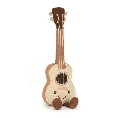 Image shows a stuffed ukulele. It has a happy face and feet.