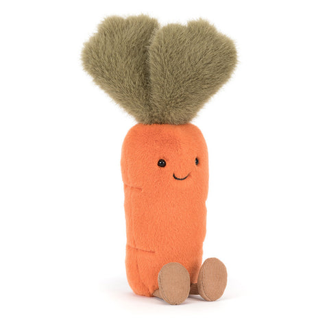 Stuffed toy carrot with a smiling face and feet on a white background