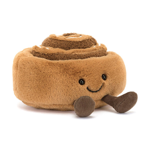 Plush cinnamon roll toy with a smiling face and feet on a white background
