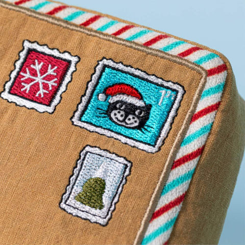 Close up of the embroidered stamps on the stuffed letter to Santa
