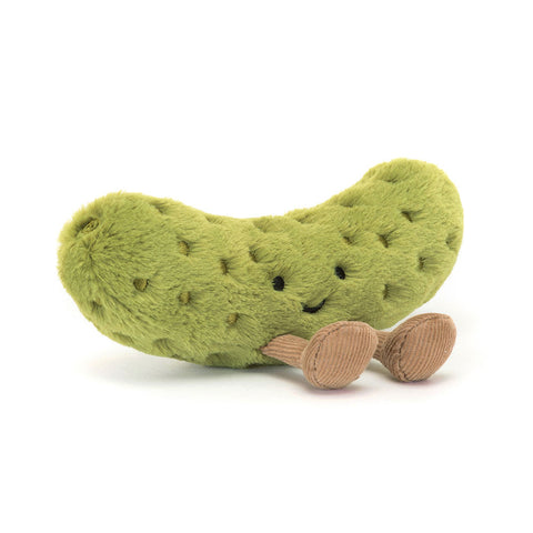 Plush toy shaped like a pickle with a smiling face and feet on a white background