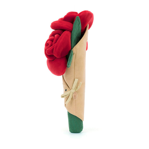 Side view of a bouquet of red plush roses in a beige wrapper on a white background