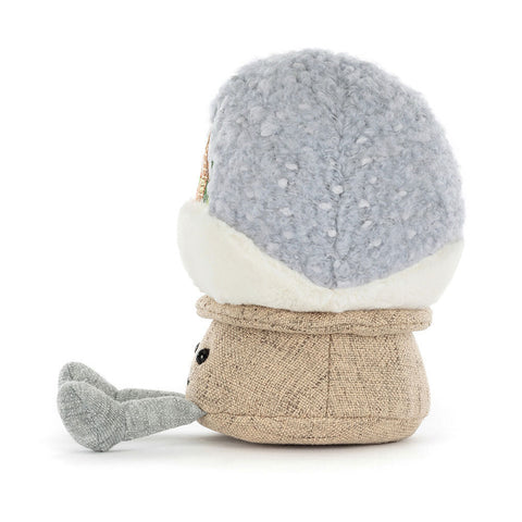 Side view of the plush snow globe toy on a white background