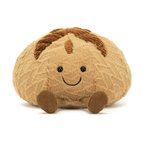 Image shows a stuffed loaf of sourdough bread. It has a happy face and feet.
