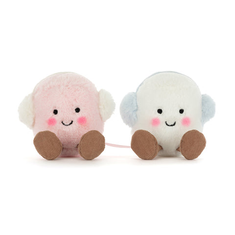 Two plush marshmallows - one pink, one white - with feet, smiling faces, and blue earmuffs