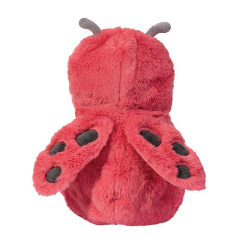 A back view of the doll wrapped in the ladybug blanket, showing its red spotted wings.