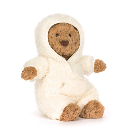 Stuffed teddy bear in a white hooded outfit on a white background