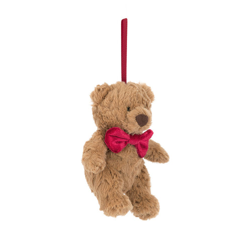 Plush teddy bear with a red bow tie on a white background. It hangs from a red ribbon.