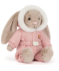 Plush toy rabbit in a pink snowsuit with white fur trim on a white background