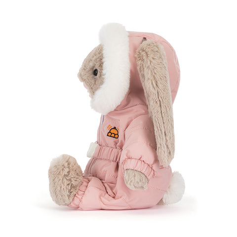 Side view of a Plush toy rabbit in a pink snow suit with white fur on a white background