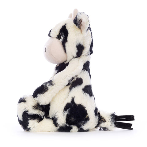 A side view of the stuffed black and white calf