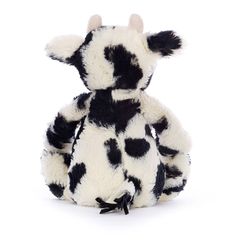 A back view of the stuffed black and white calf