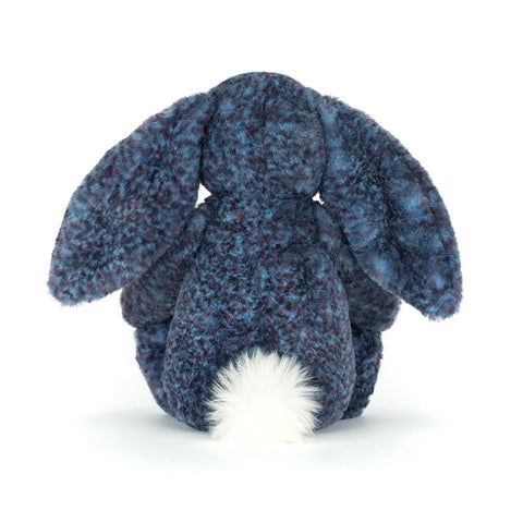 Image shows a back view of the stuffed bunny. You can see its white fluffy tail.