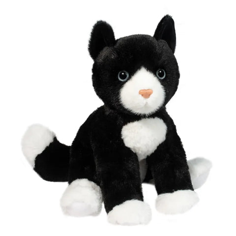 A plush black and white cat in a seated position on a white background