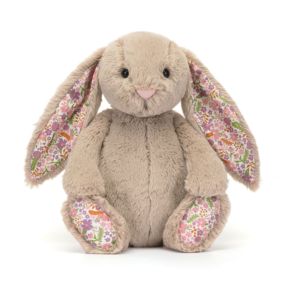 Image shows a beige stuffed bunny with floral fabric in its ears and on the bottom of its feet