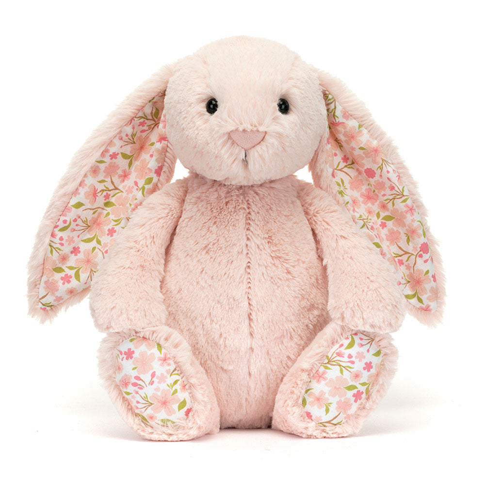 Image shows a light pink stuffed bunny with cherry blossom fabric in its ears and on the bottom of its feet