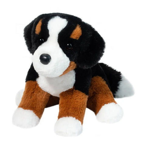 A plush toy resembling a Bernese Mountain Dog with a tricolored coat, featuring black, white, and brown colors. The toy has a soft, realistic appearance with detailed eyes and a floppy design.