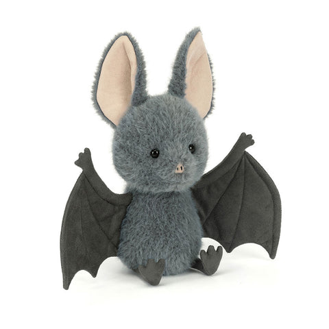 Stuffed bat toy with gray fur and black wings on a white background