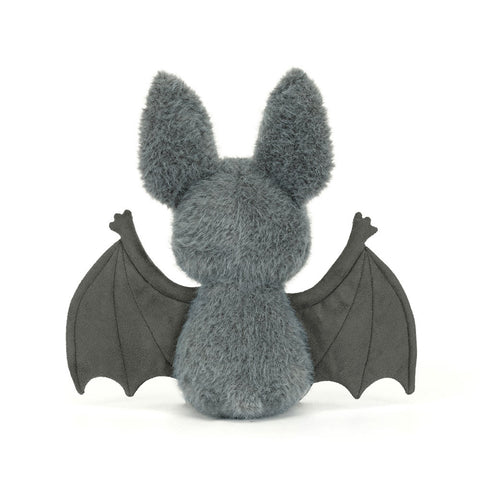 Back view of a Plush toy bat with gray fur and black wings on a white background