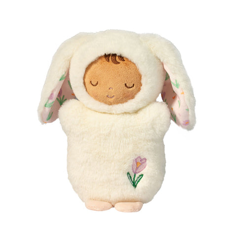 Plush toy resembling a baby in a white bunny outfit with floral details on a white background