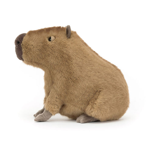 Side view of a Plush toy capybara on a white background