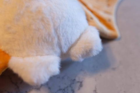 Image shows a closeup of the moth's feet. They are faux fur and look soft.