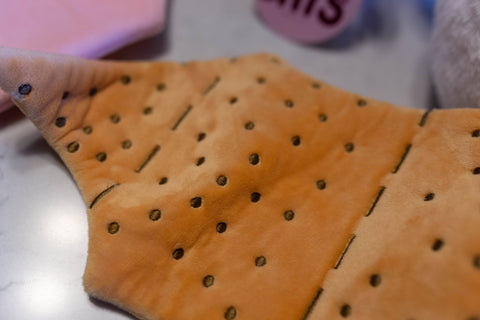 Image shows a closeup of the moth's wings. They are themed like graham crackers and look velvety.
