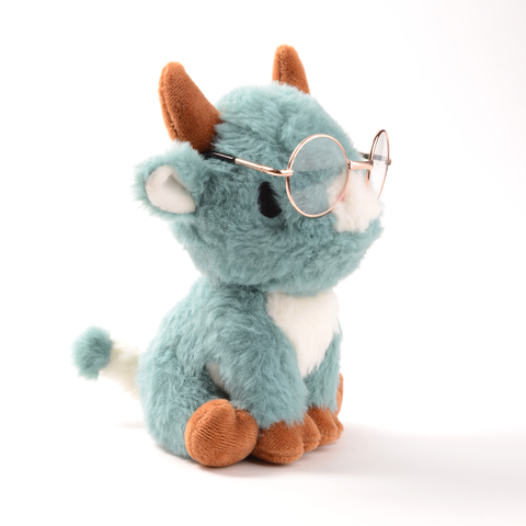 Side view of the plush blue cow wearing gold wire rimmed glasses