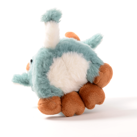 Bottom view of the plush blue cow. It has a white belly and blue and white tail.