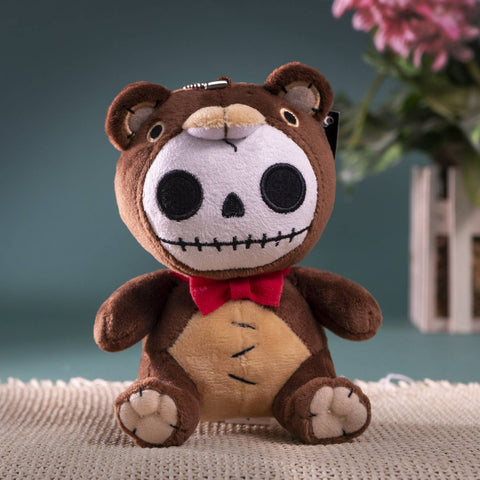 Image shows a teddy bear with a skeleton-like face. Various parts of its body are stitched together.